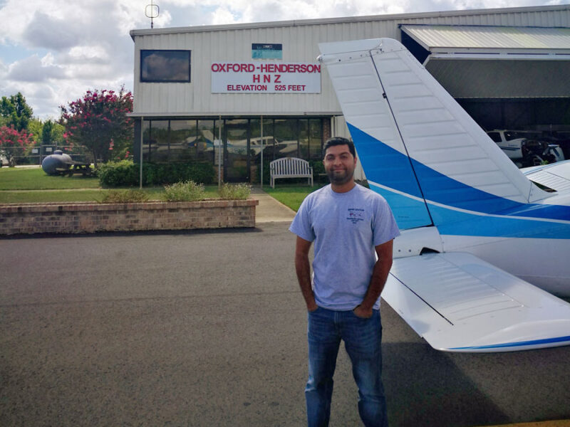 A man standing in front of an airplane.