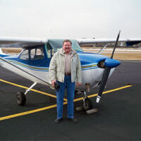 A man standing in front of an airplane.