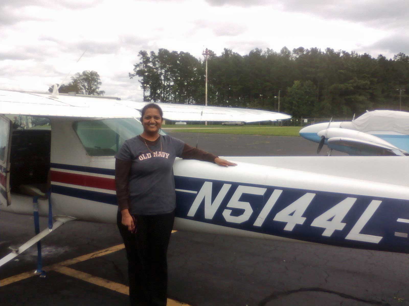 A man standing in front of an airplane.